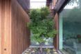 A tree in between two sections of a home