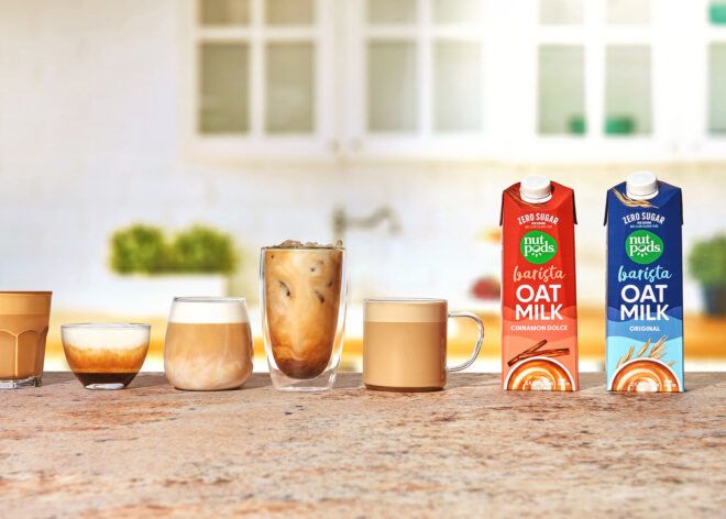 A tabletop of five glasses of coffees, espressos and at the far left are two coffee creamers from Nutpods