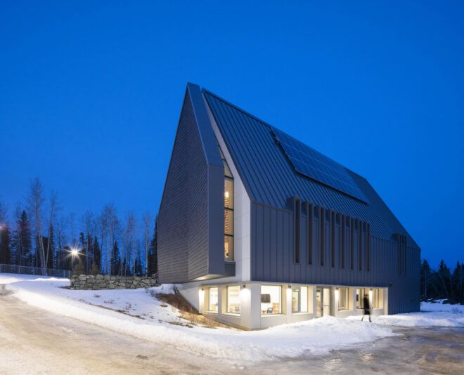 Sharp pointed roof with snow outside at night