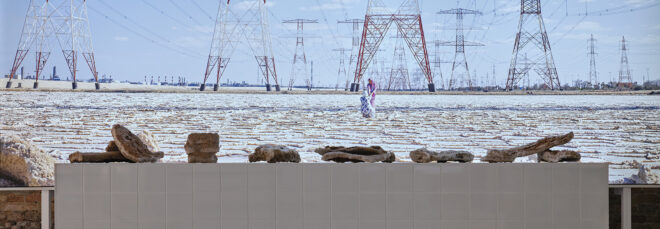 A table with an assortment rocks set with a background of powerlines