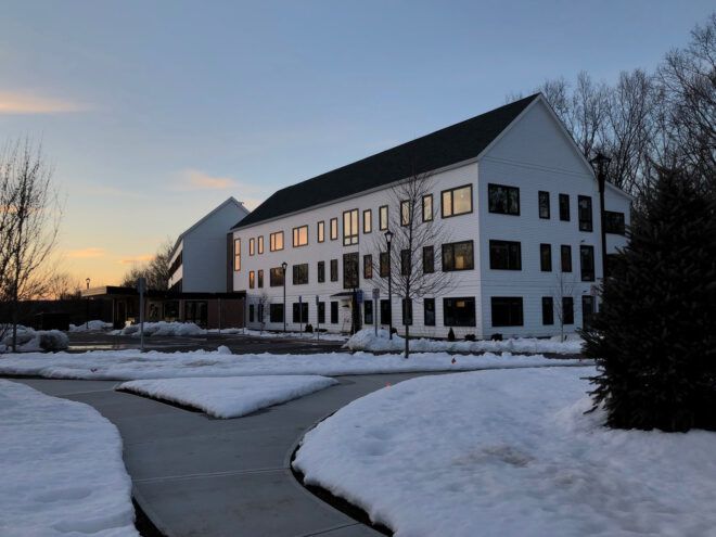 Barn-like apartment building with snow outside
