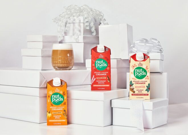 Three non-dairy creamers from Nutpods sitting on stacks of white wrapped boxes