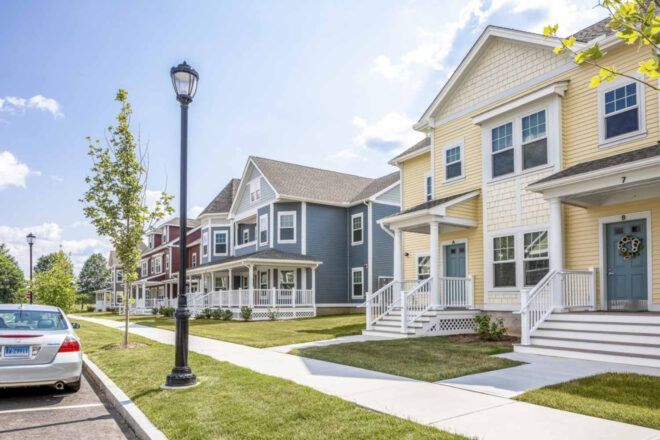 Pastel townhomes with street post outside