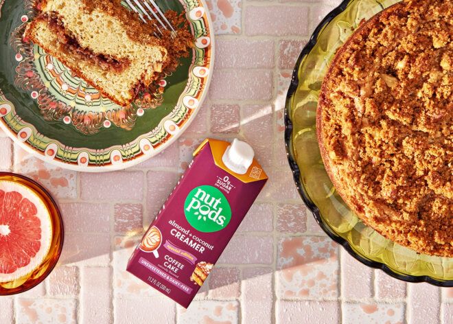 A single Nutpods coffee creamer laying in the middle of a whole cake and a slice of cake