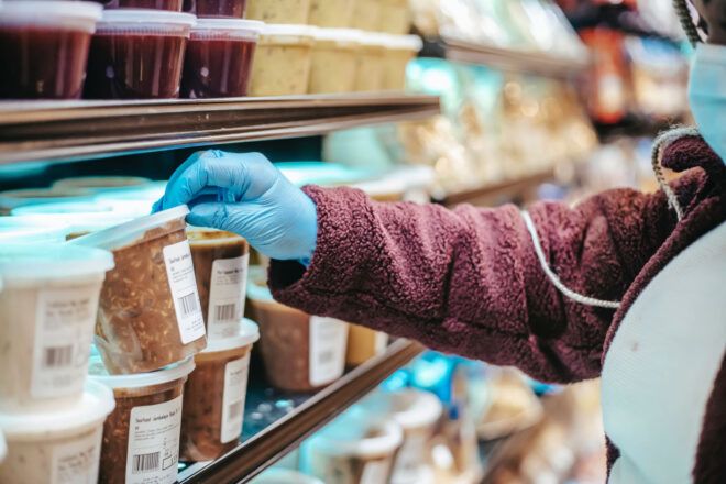 A shopper checking food labels at the grocery store