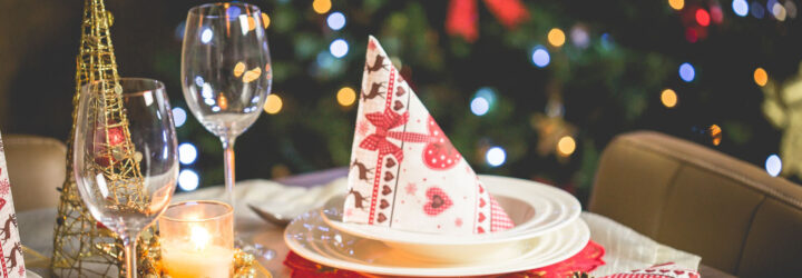 A holiday meal with Christmas tree in the back