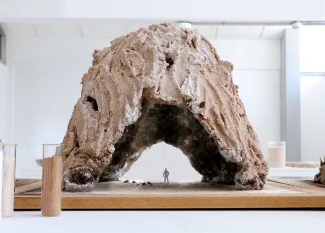 An arched sculpture made out of brown stuff