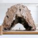 An arched sculpture made out of brown stuff