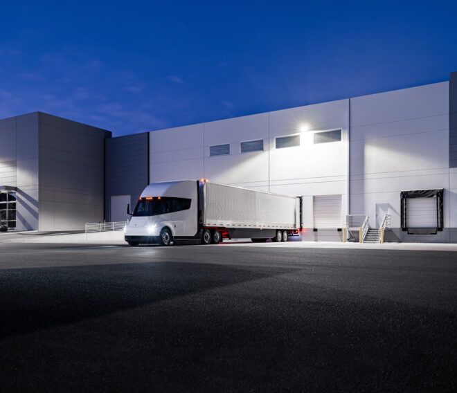 A white semi truck parked at building