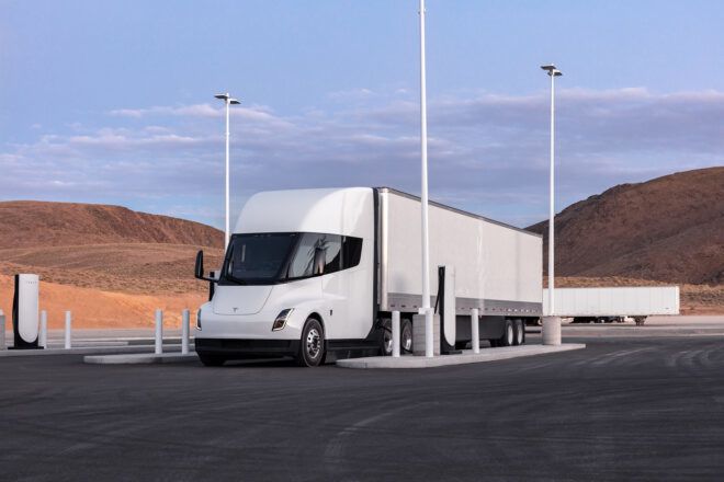A semi truck parked at a charging station