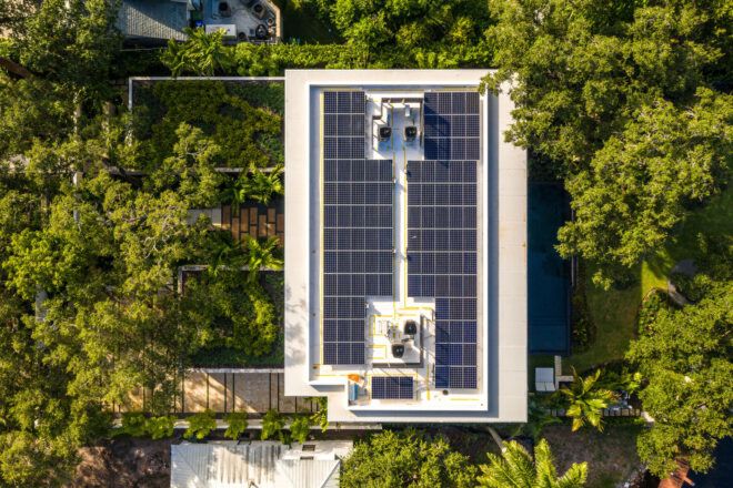 Solar panels on the roof surrounded by trees