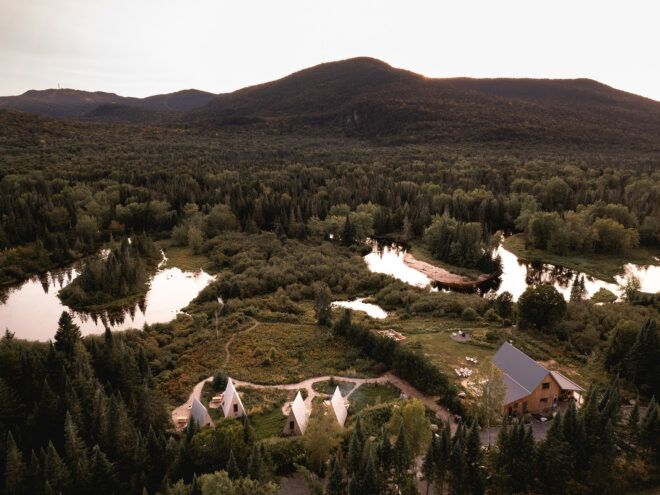 A green landscape with an area of pointed tents