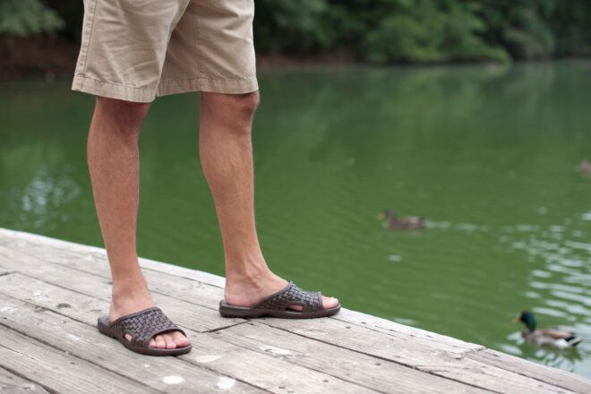 Man modeling sandals made by Okabashi
