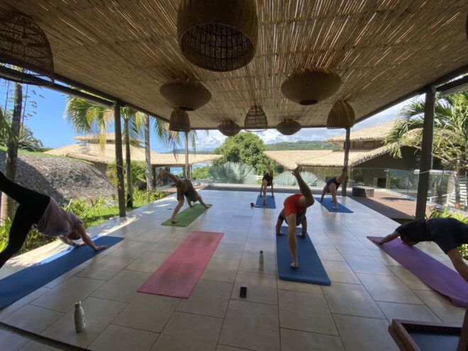 Travelers doing yoga on a hotel deck
