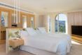 Bedroom with white sheets and quilt