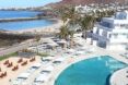 White canopies and chairs around a pool