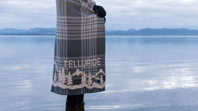 Mountain plaid blanket near lake