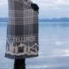 Mountain plaid blanket near lake