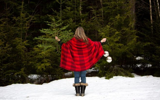 Woman modeling red checkered blanket