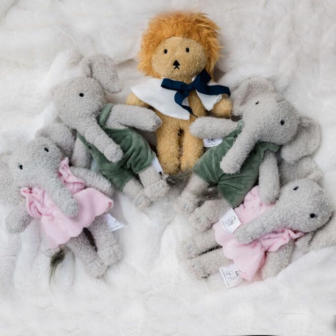 Collection of stuffed animals, one lion and two elephants