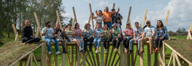 Students celebrating on one of the sloped architecture pieces