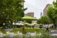 Green chairs and umbrellas in a park