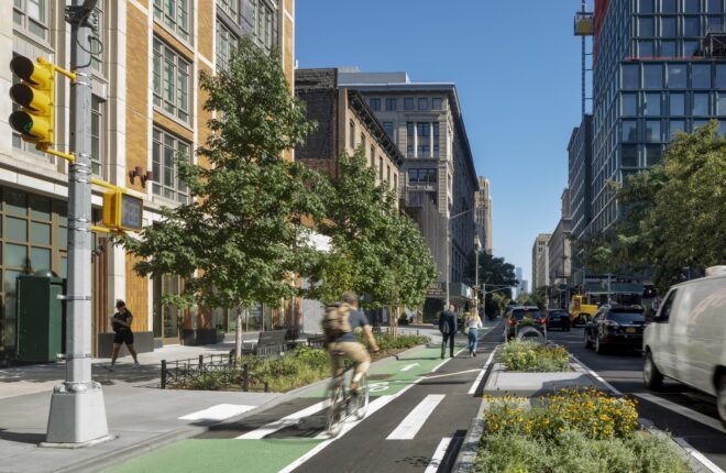 City landscape with people biking in the bike lane