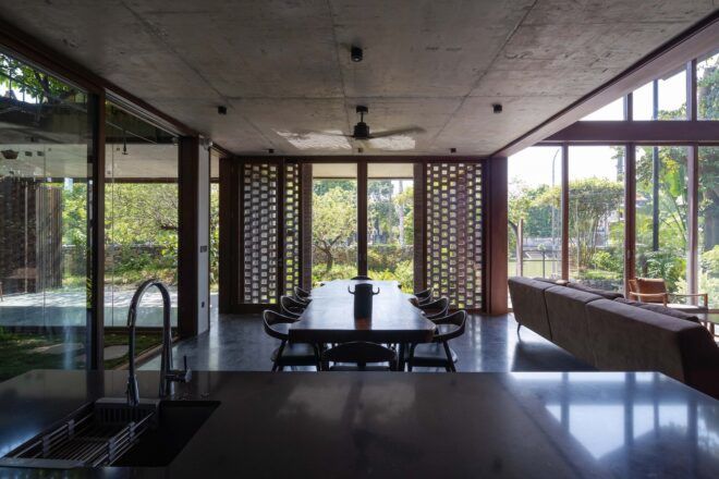 A kitchen area with a dining table in front of a sink