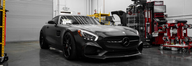 A sleek black car in a parking garage