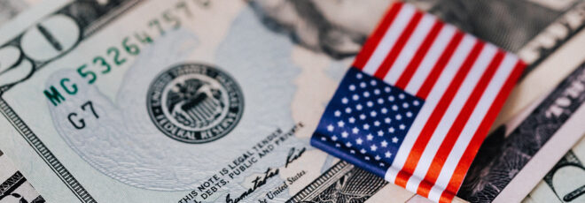 A tiny American flag laid on a $20 bill