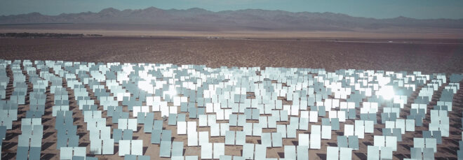 A field of reflective panels in a desert landscape