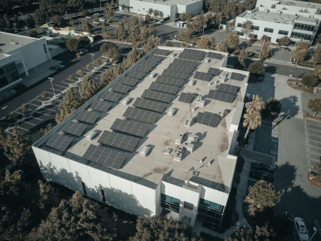 A rooftop with two rows of solar panels