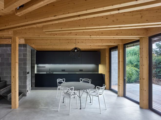 A dining area with windows and a wooden ceiling