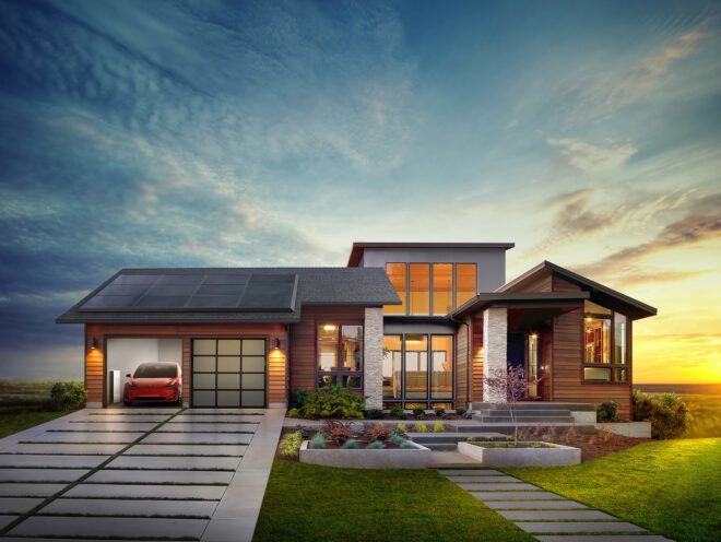 A home with a red car parked in the garage