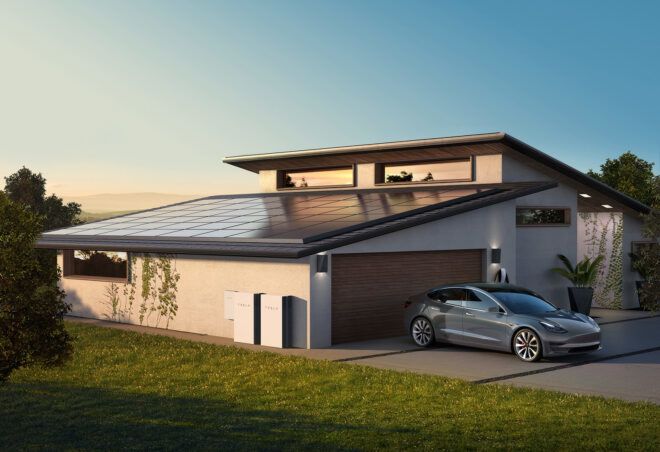 A house with solar panels on the roof and a black car parked in the driveway
