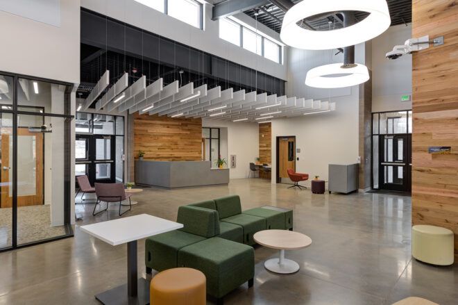An interior lobby area with circular lights hanging from the ceiling