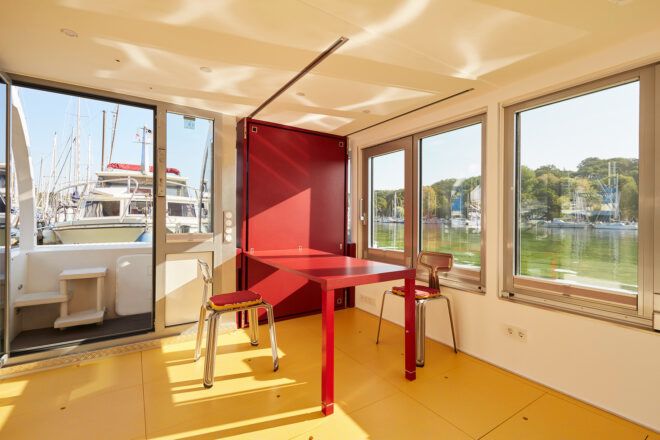 A dining space with windows looking out to the ocean