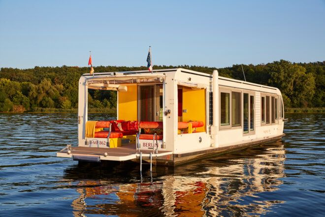 A home boat floating on a river