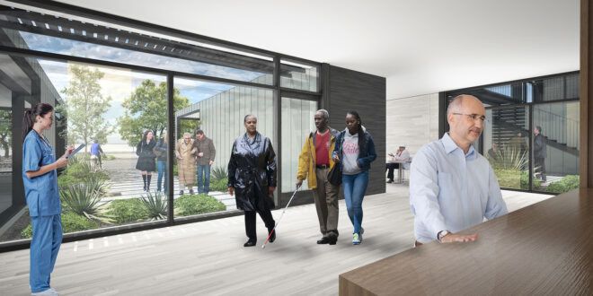An indoor gathering area with a wall of windows to the outdoor garden
