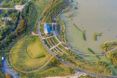 An aerial view of a park beside a river