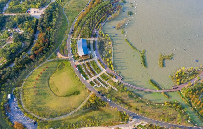 An aerial view of a park beside a river