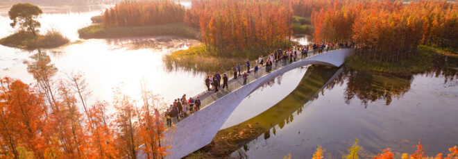 A white bridge connecting a lake
