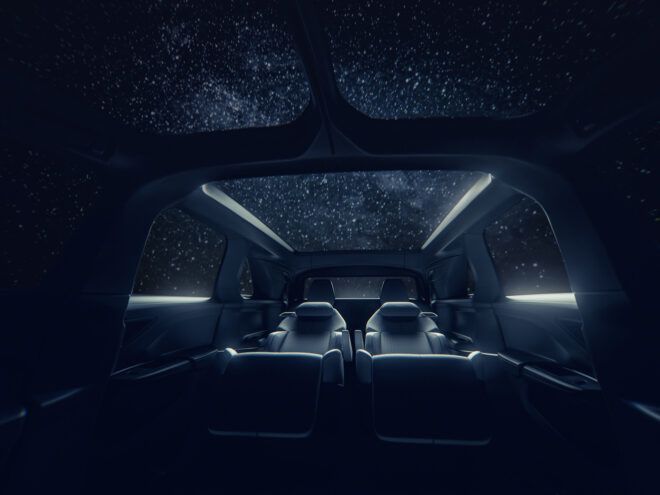 A three rows of interior vehicle seating with a view of the night sky