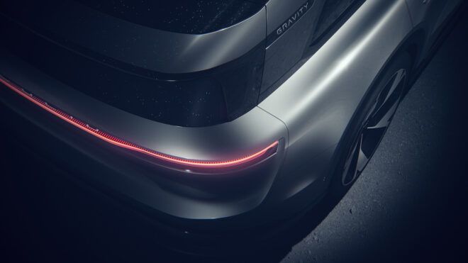 A red rear light of a silver car