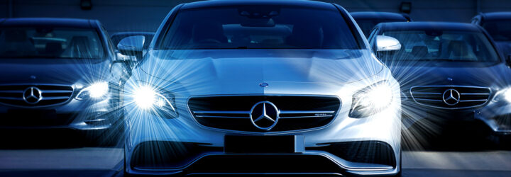 A Mercedes vehicle with two more behind it
