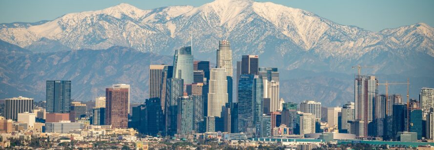A city landscape in front of a mountain range