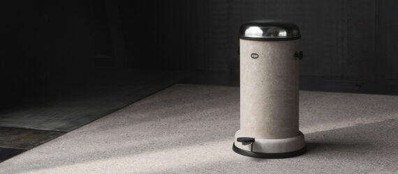 A gray trashcan with a silver lid