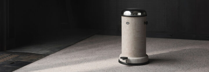 A gray trashcan with a silver lid