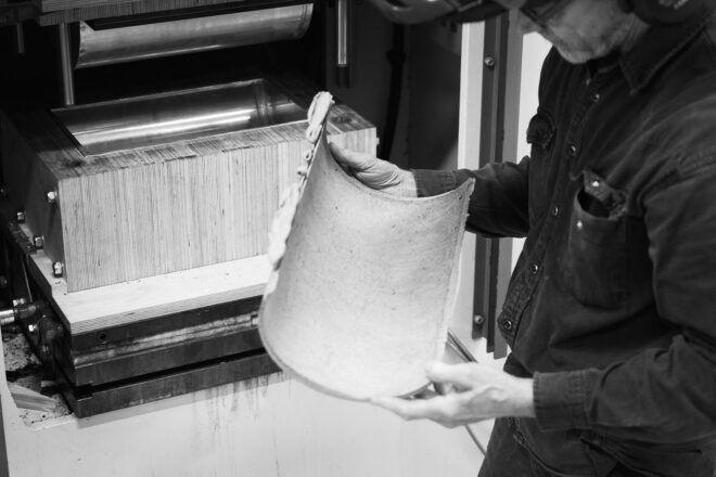 A person holding a sheet, the photo is in black and white