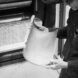 A person holding a sheet, the photo is in black and white